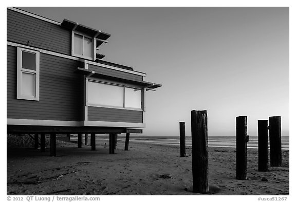 Pilings and beach house at sunset, Stinson Beach. California, USA (black and white)