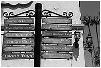 Signs pointing to local businesses, Avalon Bay, Catalina. California, USA ( black and white)