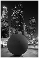 Spherical sculpture and skyscrappers at night, Pershing Square. Los Angeles, California, USA ( black and white)