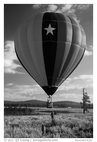 Hot air balloon low next to Prosser Reservoir, Tahoe National Forest. California, USA (black and white)
