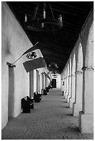 Outside arcade with Mexican and Spanish flags. California, USA ( black and white)