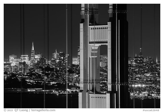 Golden Gate Bridge pillar and San Francisco skyline at night. San Francisco, California, USA (black and white)