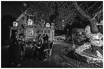 Revelers in Halloween costumes in decorated yard. Petaluma, California, USA ( black and white)