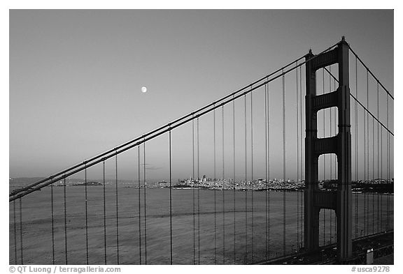 The city seen through the cables of the Golden Gate bridge, sunset. San Francisco, California, USA
