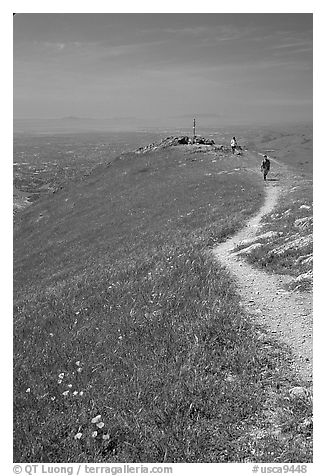 Hiker on trail at the summit of Mission Peak, Mission Peak Regional Park. California, USA (black and white)