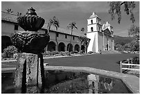 Fountain and Mission Santa Babara, mid-day. Santa Barbara, California, USA ( black and white)