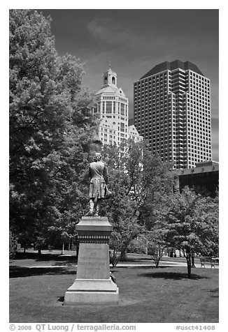 Statue in park and high-rise buildings. Hartford, Connecticut, USA (black and white)