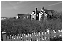 Fence and cottages in winter, Truro. Cape Cod, Massachussets, USA (black and white)