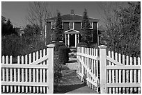 White picket fence and house, Provincetown. Cape Cod, Massachussets, USA (black and white)