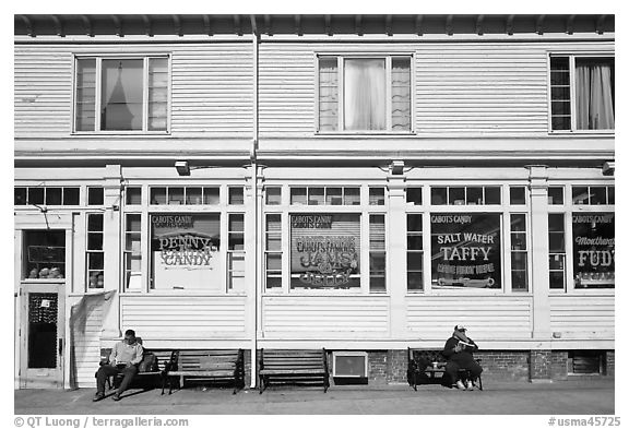Men sitting in front of candy store, Provincetown. Cape Cod, Massachussets, USA