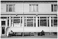 Men sitting in front of candy store, Provincetown. Cape Cod, Massachussets, USA (black and white)