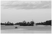 Motorboat and islets at sunset,  Moosehead Lake, Greenville. Maine, USA (black and white)