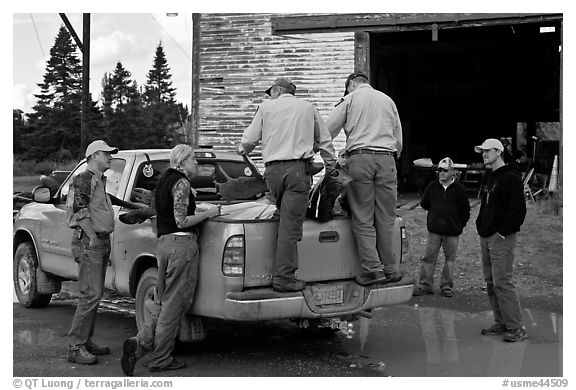 Game wardens check antler length of killed moose, Kokadjo. Maine, USA (black and white)