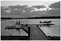 Seaplanes and dock at dusk, Ambajejus Lake. Maine, USA (black and white)