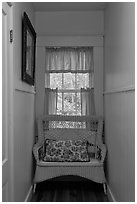 Corridor in inn with chair and window looking out to trees. Maine, USA ( black and white)