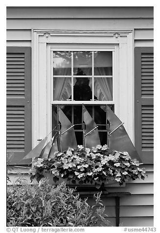 Window with decorative sailboat and flowers. Bar Harbor, Maine, USA (black and white)