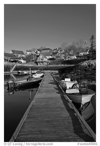 Deck, small boats, and houses. Stonington, Maine, USA (black and white)