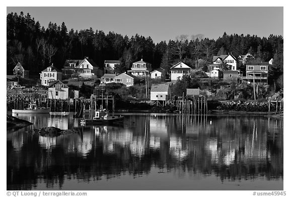 Reflection of hillside houses. Stonington, Maine, USA (black and white)