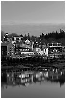 Houses with lights reflected in harbor. Stonington, Maine, USA (black and white)