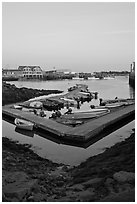 Small boats and harbor at sunset. Stonington, Maine, USA (black and white)