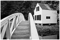Wooden arched footbridge and house. Maine, USA (black and white)