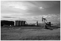 Oil pumpjack and tanks. North Dakota, USA (black and white)