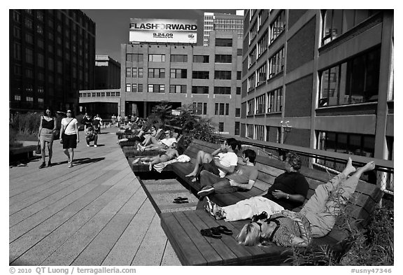 People sunning themselves on the High Line. NYC, New York, USA