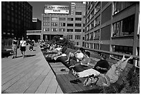 People sunning themselves on the High Line. NYC, New York, USA ( black and white)