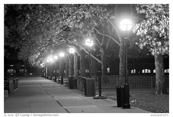 Row of lights by night, Ellis Island. NYC, New York, USA (black and white)