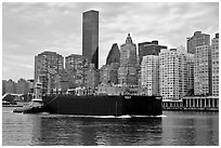 Barge on Hudson River and Manhattan waterfront. NYC, New York, USA ( black and white)