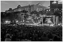 Outdoor musical performance at night with QTL photo as screen backdrop, Central Park. NYC, New York, USA ( black and white)
