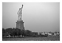 Statue of Liberty and Liberty Island from the back, sunset. NYC, New York, USA ( black and white)