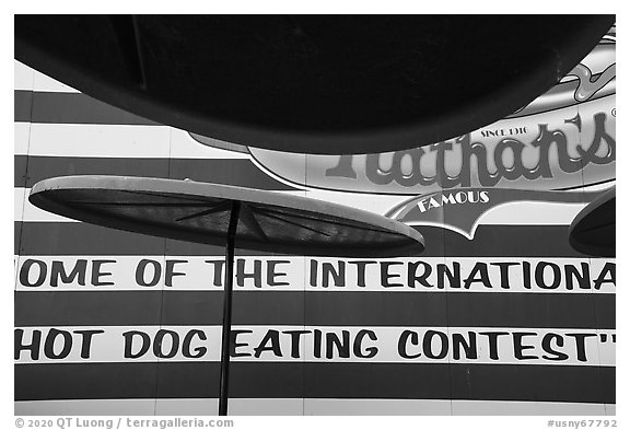 Sun umbrellas and hot dog eating contest wall. New York, USA (black and white)
