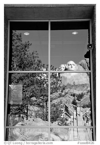 Cliff and sculptures reflected in a window, Mount Rushmore National Memorial. South Dakota, USA