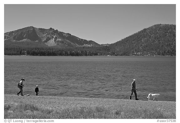 Family strolling on shore of East Lake. Newberry Volcanic National Monument, Oregon, USA