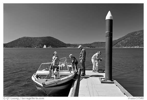 Family boarding boat, East Lake. Newberry Volcanic National Monument, Oregon, USA (black and white)