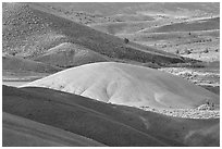 Bare ash mounds and sagebrush-covered slopes. John Day Fossils Bed National Monument, Oregon, USA (black and white)