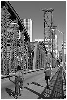 Jogger and cyclist on Hawthorne Bridge. Portland, Oregon, USA ( black and white)
