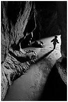 Infant walking out of sea cave. Bandon, Oregon, USA (black and white)
