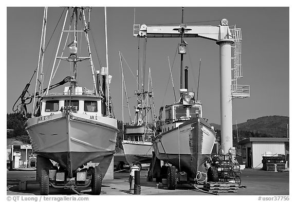 Fishing boats parked on deck with hoist behind, Port Orford. Oregon, USA
