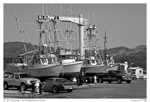 Fishing boats and cars parked on deck, Port Orford. Oregon, USA (black and white)