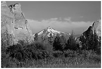 Snow-capped volcano seen between rock pinnacles. Smith Rock State Park, Oregon, USA ( black and white)