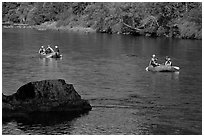 Two Rafts passing boulder, McKenzie river. Oregon, USA ( black and white)
