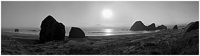 Pacific coastal scenery with setting sun, Pistol River State Park. Oregon, USA (Panoramic black and white)