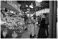 Countermen offer fish samples, Pike Place Market. Seattle, Washington (black and white)