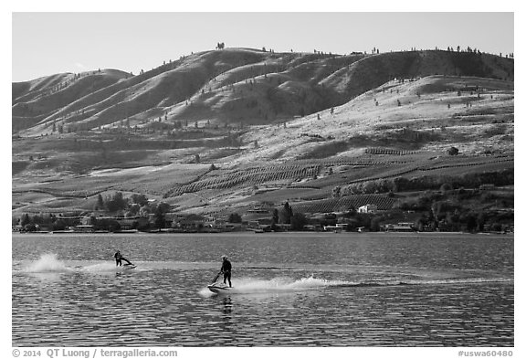 Personal watercraft riders and vineyard covered hills, Lake Chelan. Washington (black and white)
