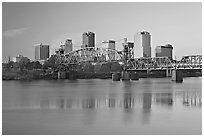 Skyline and bridge with reflections in river at sunrise. Little Rock, Arkansas, USA ( black and white)
