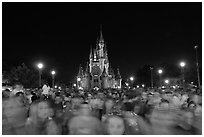 Crowds on Main Street with castle in the back at night. Orlando, Florida, USA ( black and white)