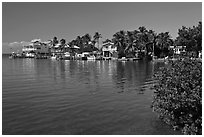 Conch cottages lining edge of Florida Bay, Conch Key. The Keys, Florida, USA (black and white)