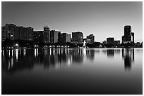 Orlando skyline at sunset reflected in lake Eola. Orlando, Florida, USA ( black and white)